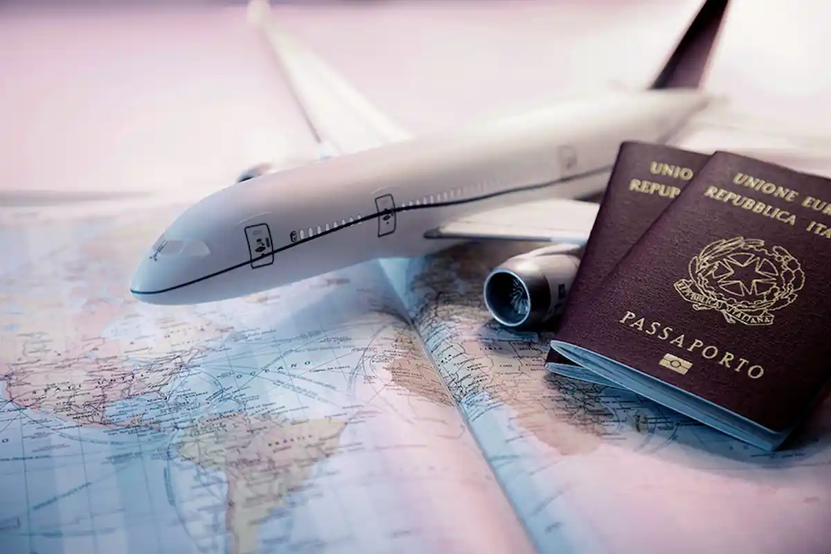 Can I Travel Internationally With A Misdemeanor: Yes or No? 3 A model airplane is placed on a world map, next to two Italian passports. The scene suggests travel and adventure. The map features geographic details, while the passports lie slightly open. The overall lighting is soft, creating a nostalgic atmosphere.
