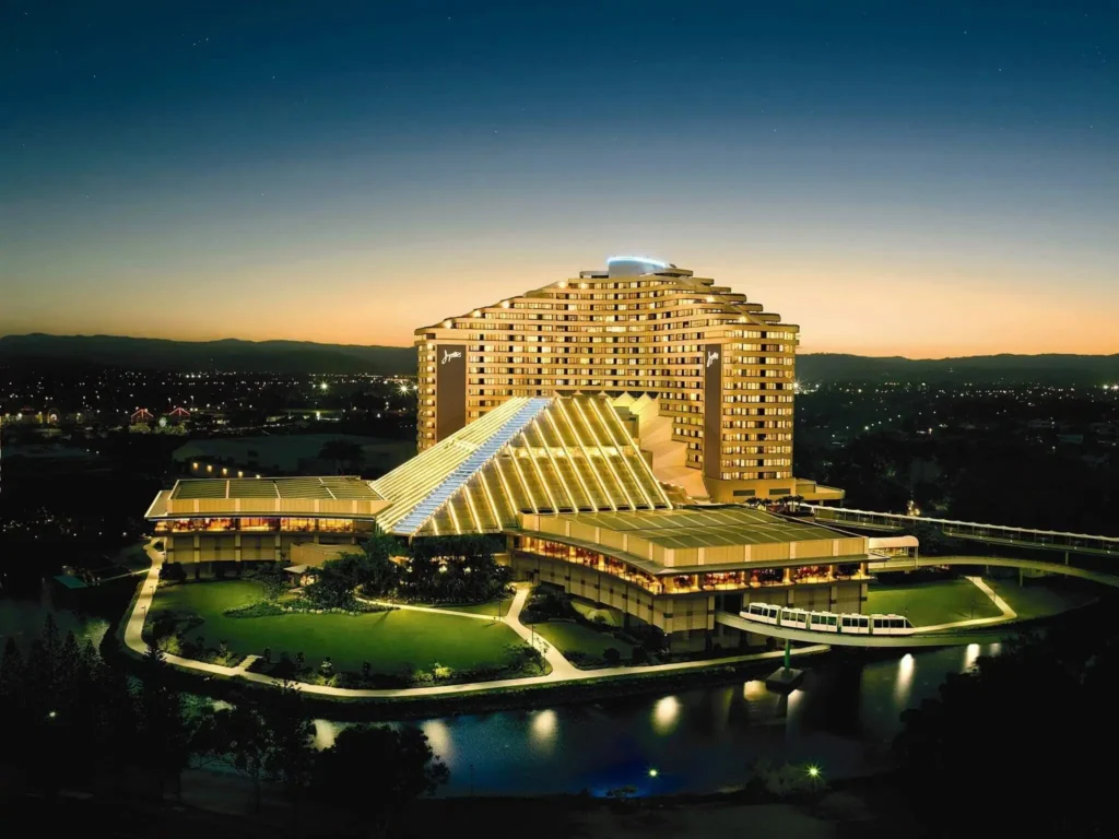Where to Stay in Portland? 12 Top Rated Places in 2024 8 A large, illuminated hotel complex with a distinctive pyramid-shaped tower. The hotel is surrounded by landscaped grounds and is located near a body of water. A monorail system runs along the property. The image likely depicts the Jupiter's Casino and Hotel in Gold Coast, Australia.